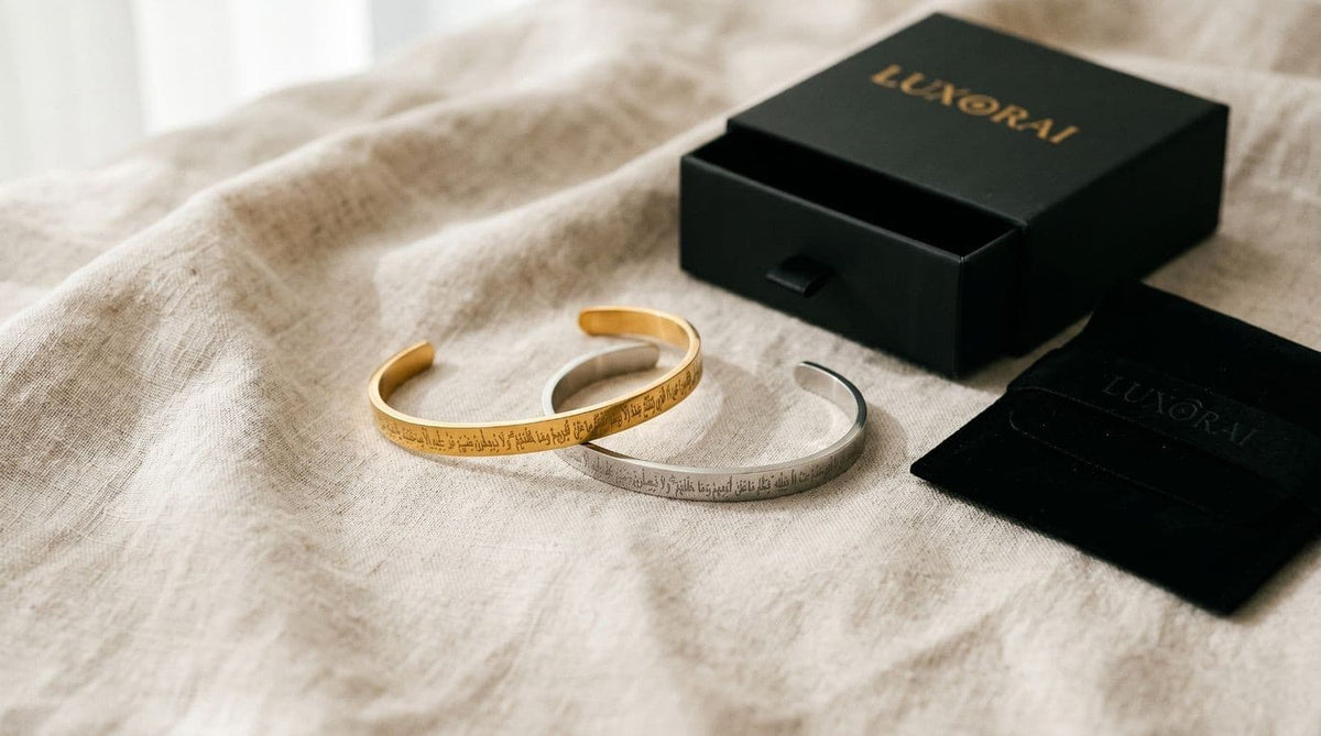 Two gold and silver bracelets on a beige fabric surface with a Luxorai box and pouch.